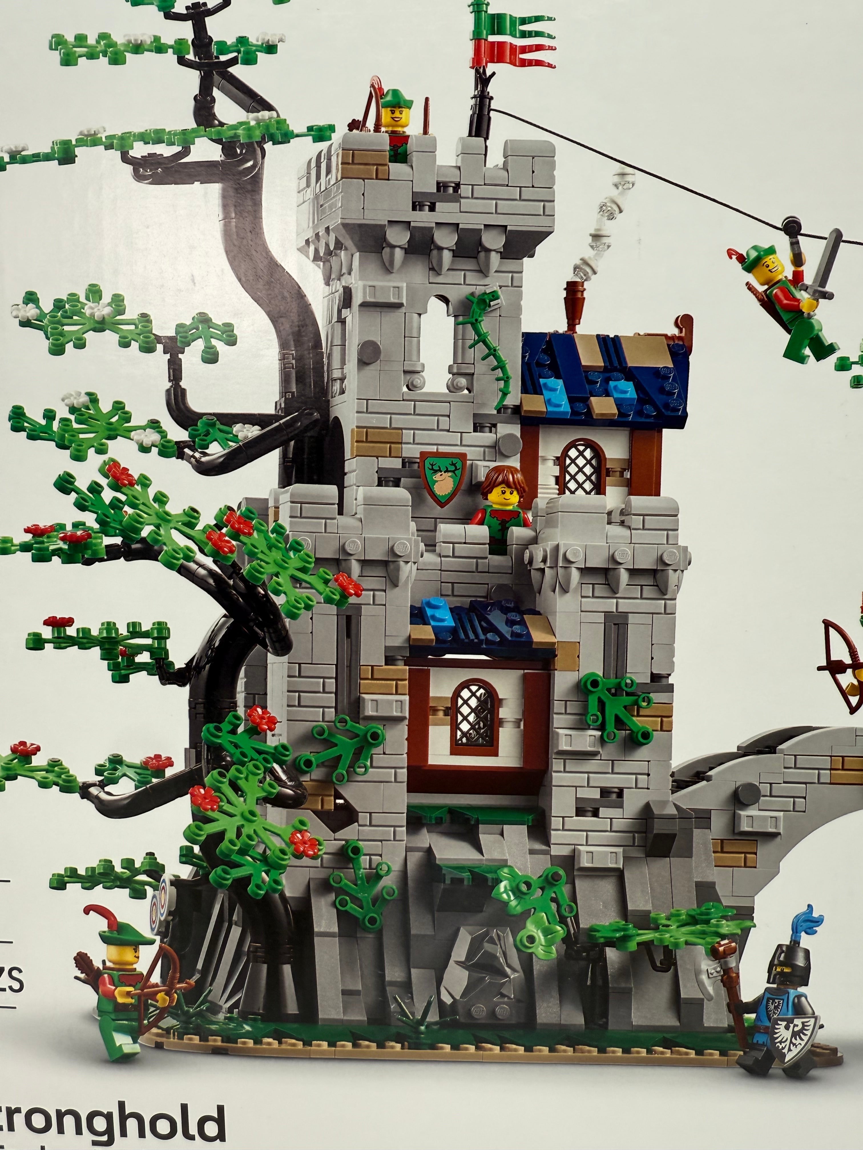Legacy Brick LEGO Forest Stronghold set 910043 featuring a detailed stone castle, large tree, and minifigures.